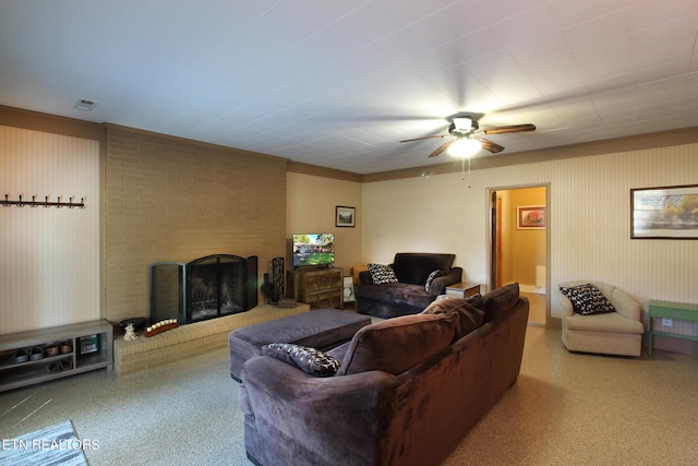 carpeted living room with ceiling fan and a fireplace