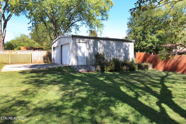 view of outbuilding with a garage and a lawn