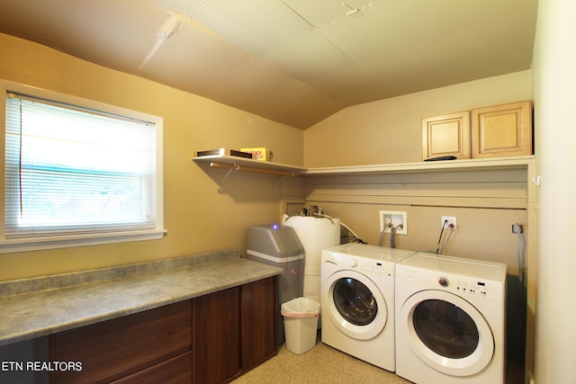 washroom featuring washer and clothes dryer and cabinets