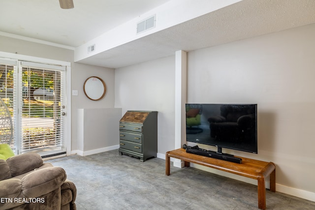 sitting room with crown molding and a textured ceiling