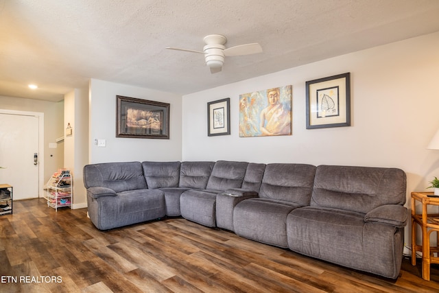 living room with dark hardwood / wood-style floors, a textured ceiling, and ceiling fan