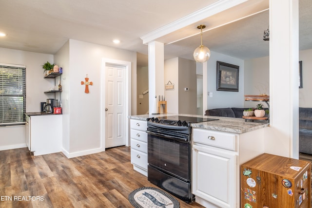 kitchen featuring white cabinets, black range with electric stovetop, dark hardwood / wood-style floors, pendant lighting, and light stone counters