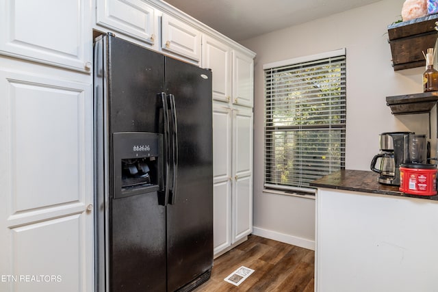 kitchen featuring white cabinets, dark wood-type flooring, and black fridge with ice dispenser