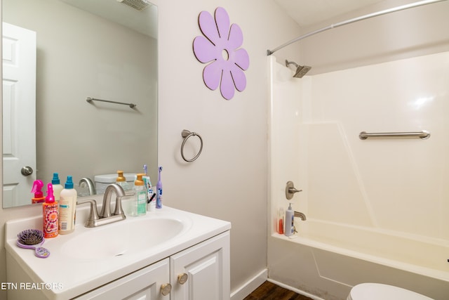 full bathroom with vanity, bathing tub / shower combination, toilet, and wood-type flooring