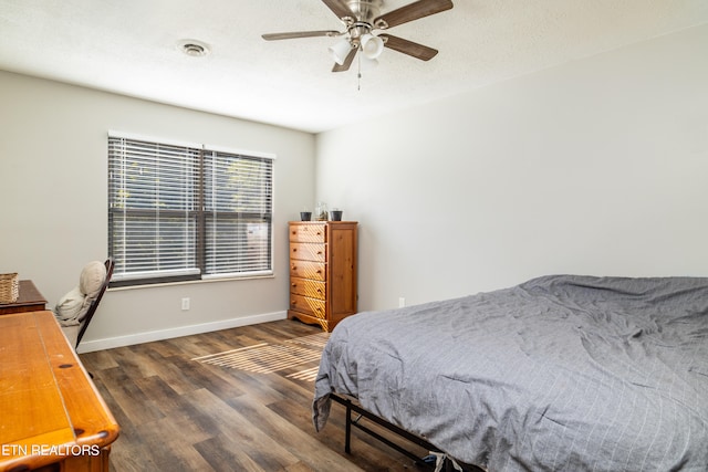 bedroom with ceiling fan and dark hardwood / wood-style flooring