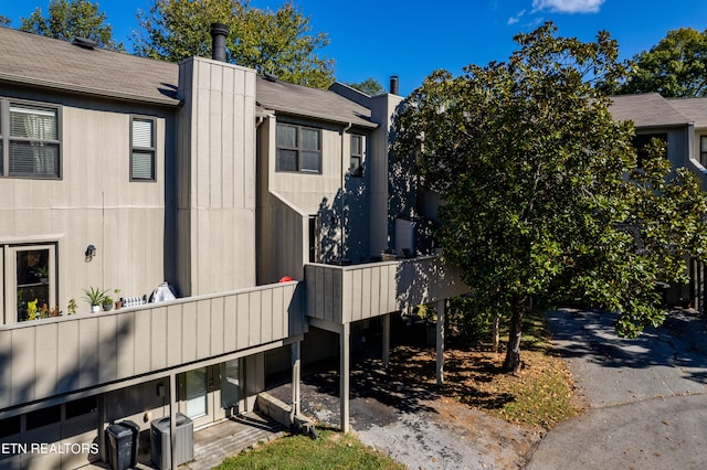 view of side of home with central AC unit