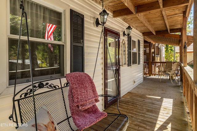 wooden terrace featuring covered porch