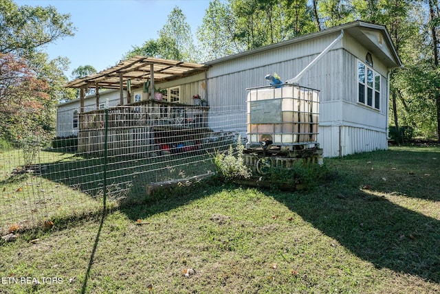 view of home's exterior with a pergola and a lawn