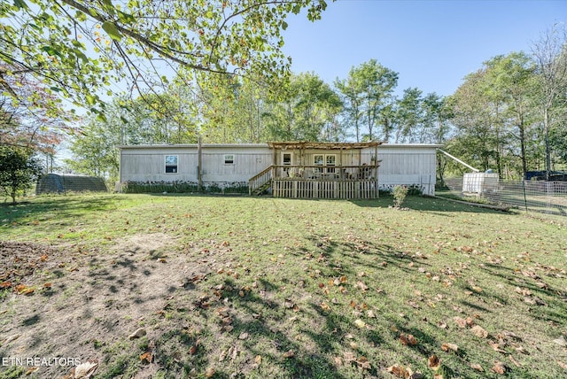 back of house with a yard and a deck