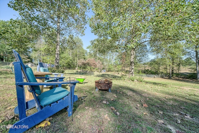 view of yard with a fire pit