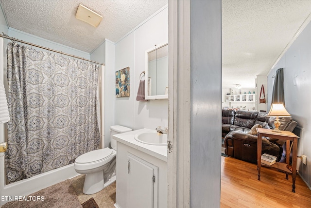 bathroom with a textured ceiling, hardwood / wood-style floors, toilet, vanity, and ornamental molding