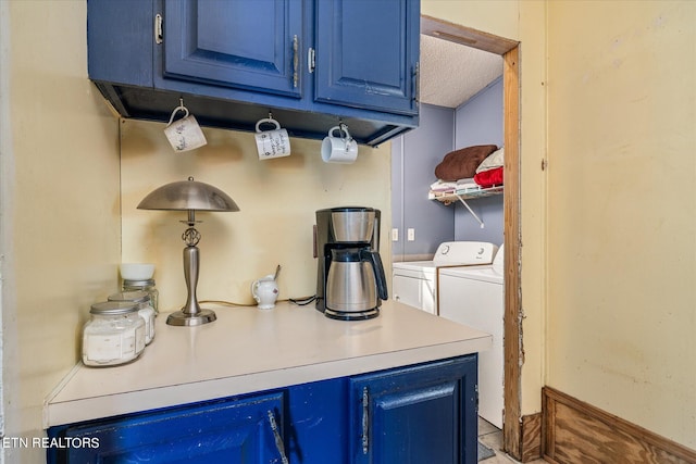 clothes washing area with washer and dryer