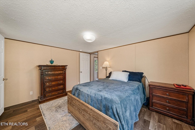 bedroom featuring a textured ceiling and dark wood-type flooring