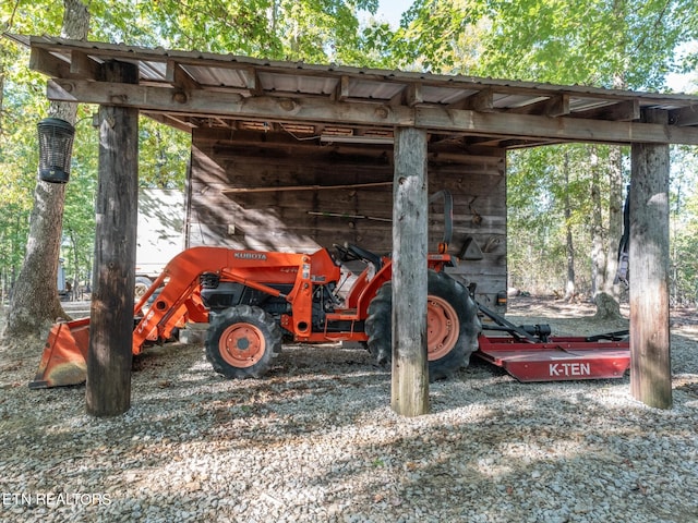 view of parking / parking lot featuring a carport