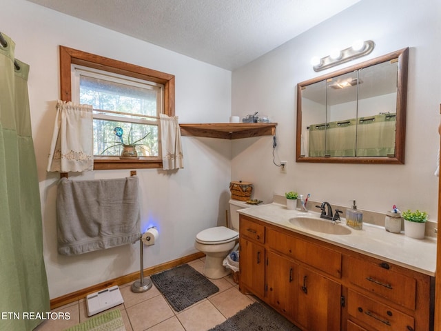 bathroom featuring vanity, toilet, a textured ceiling, and tile patterned floors