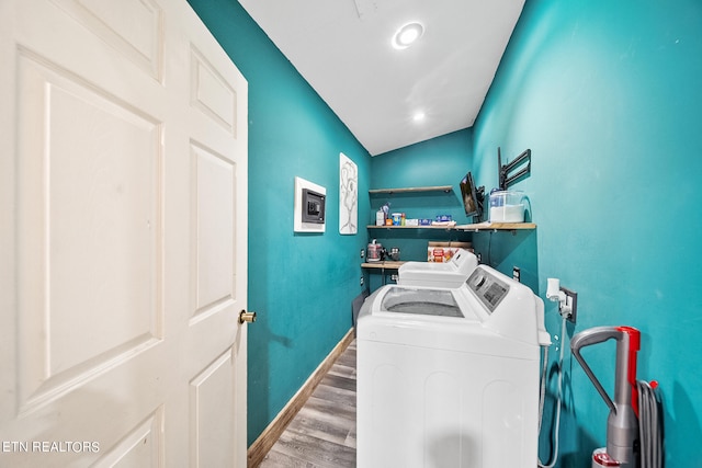 clothes washing area with wood-type flooring and separate washer and dryer