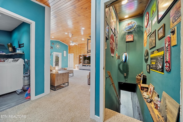 corridor with lofted ceiling, wooden ceiling, carpet floors, and washing machine and clothes dryer