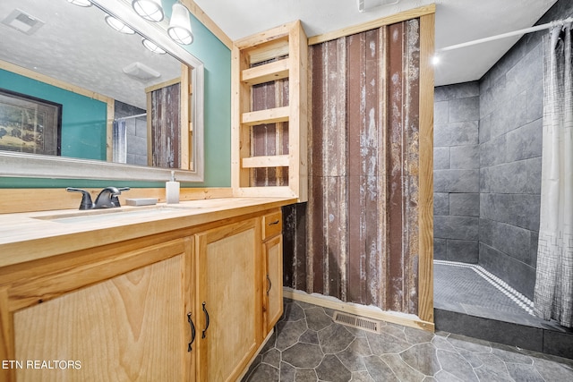 bathroom featuring vanity and curtained shower