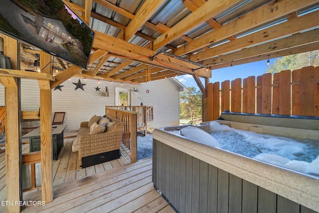 wooden terrace with a hot tub and an outdoor hangout area