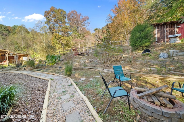 view of yard with a fire pit