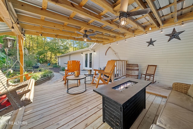 wooden deck featuring an outdoor fire pit and ceiling fan