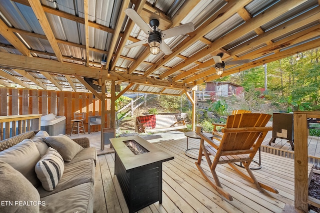 deck featuring an outdoor living space with a fire pit and ceiling fan