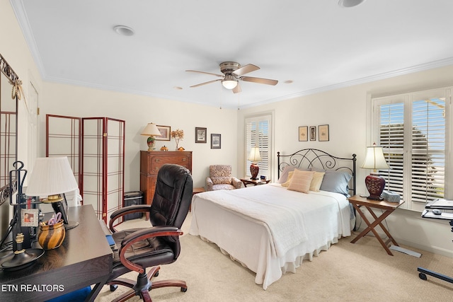 carpeted bedroom featuring crown molding and ceiling fan