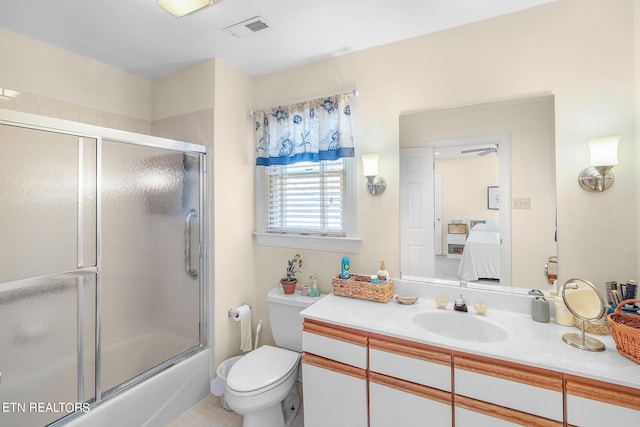 full bathroom featuring vanity, toilet, shower / bath combination with glass door, and tile patterned flooring