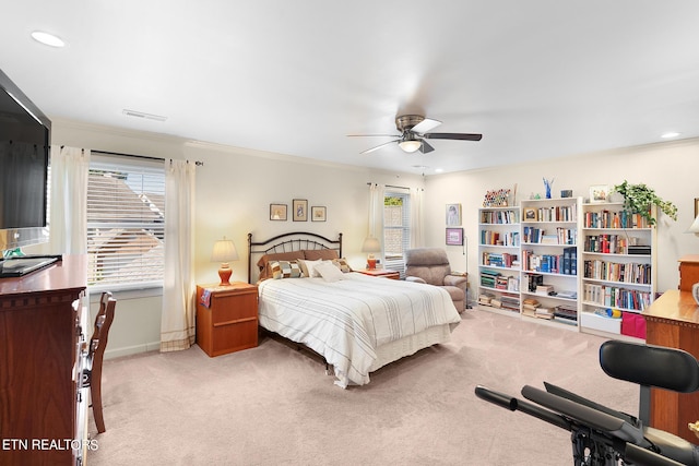 bedroom featuring crown molding, light colored carpet, and ceiling fan