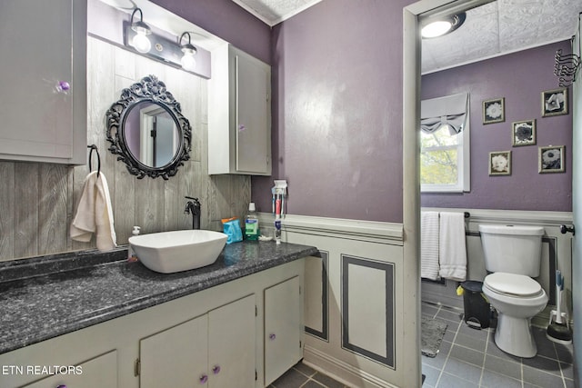 bathroom with vanity, toilet, and tile patterned flooring