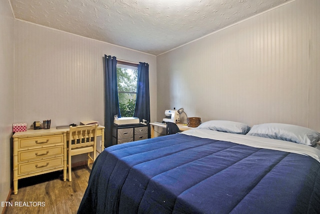 bedroom featuring dark wood-type flooring and a textured ceiling