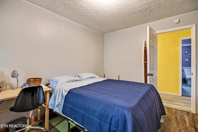 bedroom featuring dark wood-type flooring and a textured ceiling