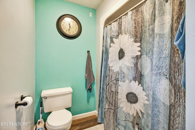 bathroom with a shower with curtain, wood-type flooring, and toilet