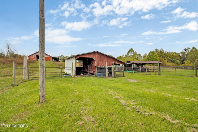 view of yard with a rural view and an outbuilding