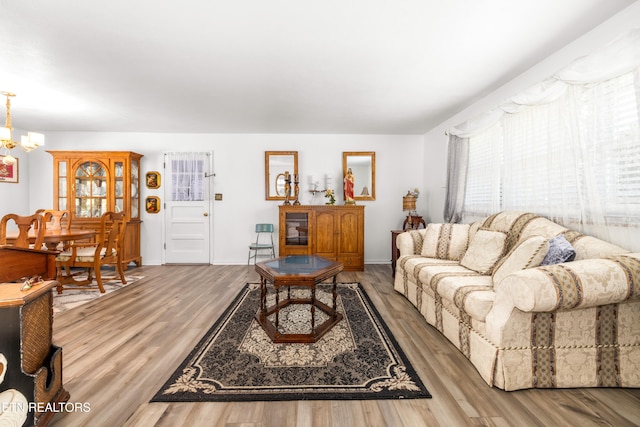 living room featuring hardwood / wood-style floors and a chandelier