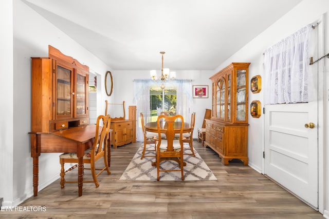 dining room with a chandelier and wood-type flooring