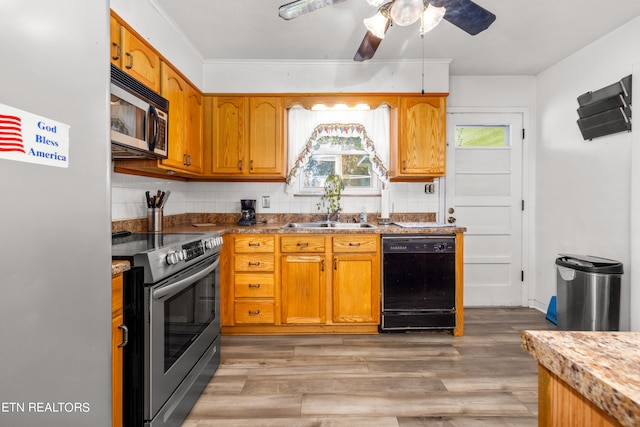 kitchen featuring light hardwood / wood-style flooring, tasteful backsplash, stainless steel appliances, and sink