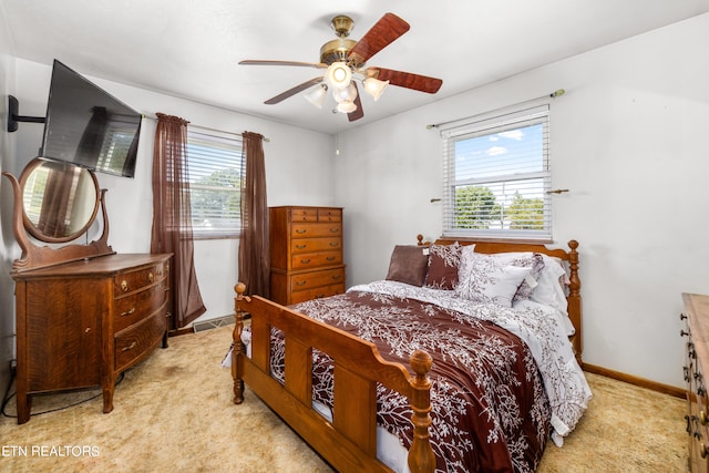 bedroom featuring light colored carpet and ceiling fan