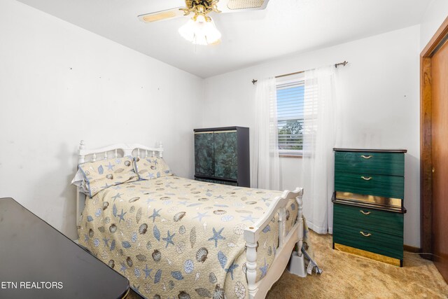 bedroom with ceiling fan and light carpet