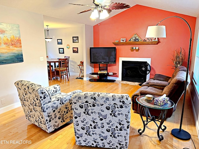 living room with ceiling fan and wood-type flooring