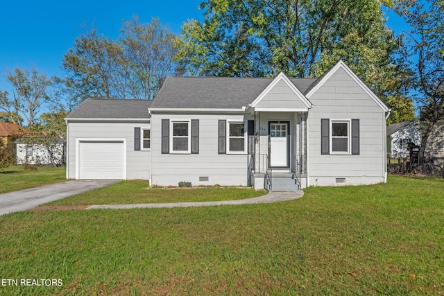 view of front of home featuring a front yard and a garage