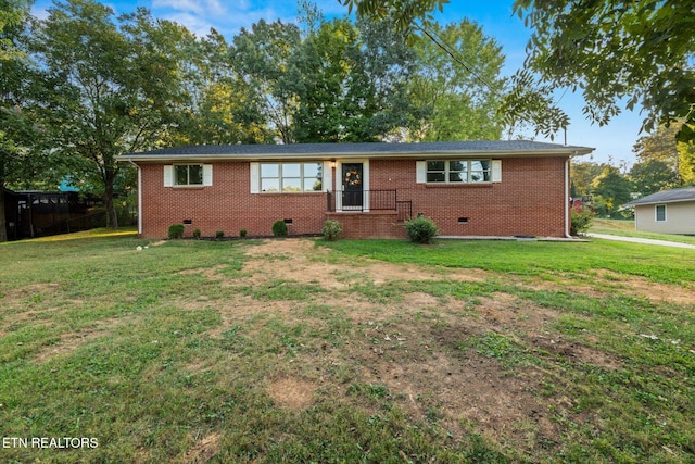 ranch-style home with a front lawn