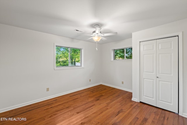 unfurnished bedroom featuring a closet, ceiling fan, and hardwood / wood-style floors