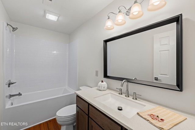 full bathroom with hardwood / wood-style floors, vanity,  shower combination, and toilet