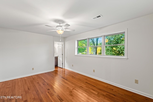 spare room with ceiling fan and hardwood / wood-style flooring