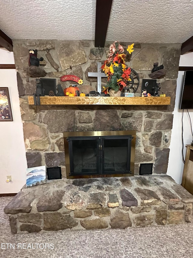 details featuring beamed ceiling, a stone fireplace, a textured ceiling, and carpet floors