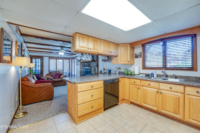 kitchen with a paneled ceiling, black dishwasher, sink, and a wealth of natural light