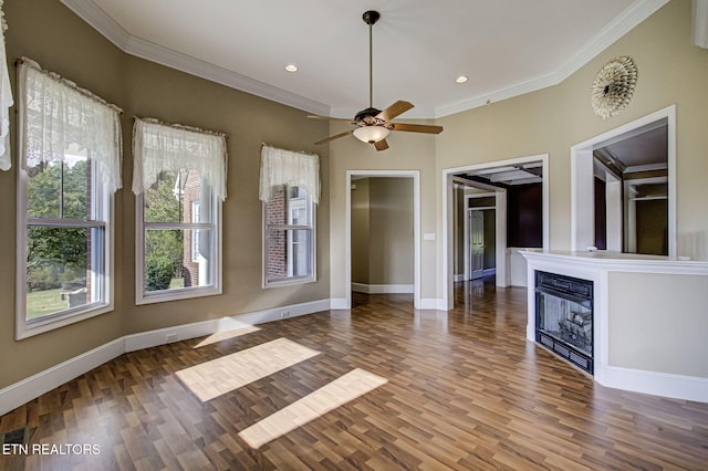 empty room with wood-type flooring, ceiling fan, and ornamental molding