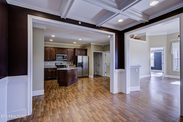 kitchen with beam ceiling, a center island, stainless steel appliances, coffered ceiling, and crown molding