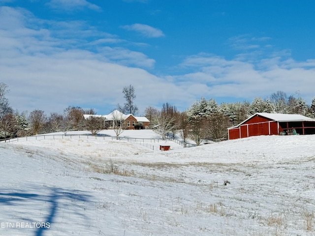 snowy yard with an outbuilding